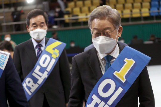 26일 전북 완주군 우석대학교 체육관에서 열린 더불어민주당 대선 후보 선출을 위한  전북 합동연설회에서 이재명(오른쪽) 후보와 이낙연 후보가 연설장을 나가고 있다. <완주=연합뉴스>